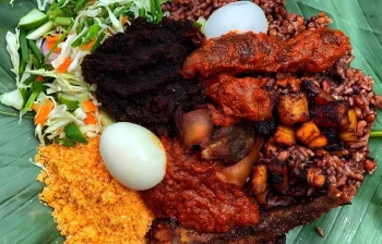 Waakye with wele, egg, fish and spaghetti